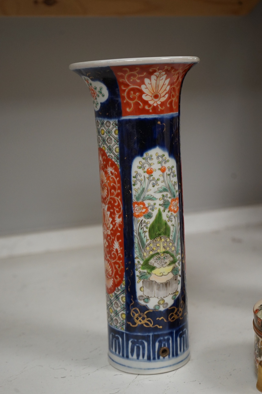 A Japanese Satsuma circular box and cover, a similar vase and an Imari sleeve vase, largest 30cm high. Condition - sleeve vase cracked, others good